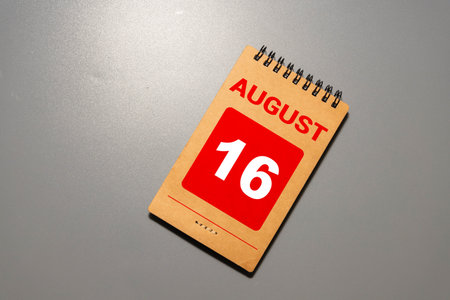 August 16th. Image of August 16 wooden color calendar on blue background. Summer day. Empty space for textの写真素材