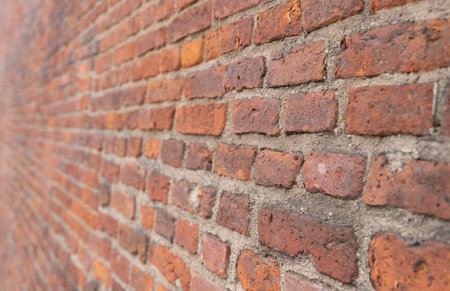Red brick wall texture background with weathered bricks, cement joints, and an aged, grungy...