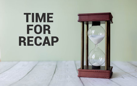 The text TIME FOR RECAP appearing on yellow paper behind torn color paper.