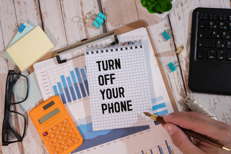 Business man pointing the text Turn Off Your Phone