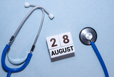 Vintage photo, August 28th. Date of August 28 on wooden cube calendar, copy space for text on board