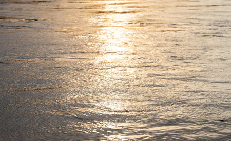 Sunny path on the water. The sun has bowed low to the horizon,