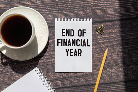 focus on wooden blocks with letters making End of Financial Year text.