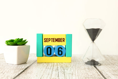 September 6th. Image of September 6 wooden color calendar on white background. Empty space for text