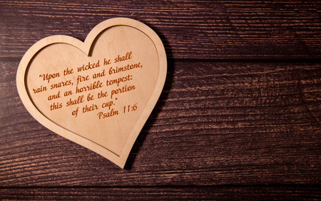 London, United Kingdom - December 12, 2021: An open Bible, opened to the book of Psalms chapter 11,...
