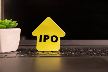 A stack of wooden cubes with IPO letters on a wooden table. Stock investment conceptの写真素材