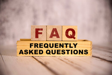 FAQ ( frequently asked questions ) text on notebook with many light bulbsの写真素材