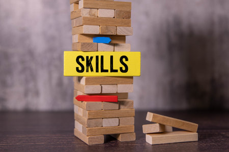 SKILL; Wooden blocks with SKILL text of concept and a human toy.