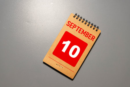 Wooden calendar organizer with date September 10 on tableの写真素材