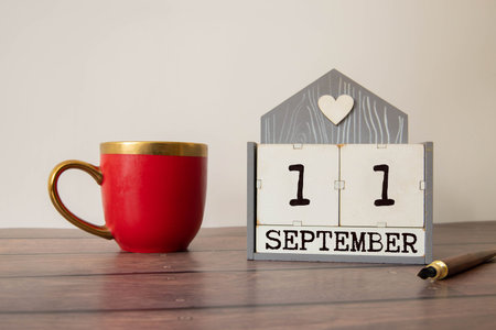 September 11th.September 11 white wooden calendar on wood background.Copyspace for text.Autumn day.