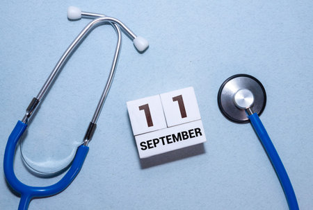 September 11th.September 11 white wooden calendar on wood background.Copyspace for text.Autumn day.