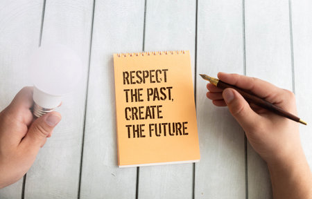 Wooden blocks display the phrase 'respect the past, create the future', symbolizing the importance...