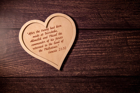 Where your treasure is, there is your heart, handwritten text note on wooden table. Top view. Biblical concept of Christian priority, love and obedience to God Jesus Christ.の写真素材