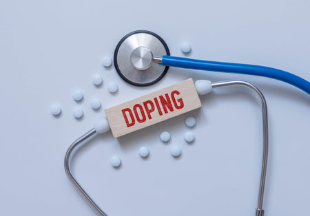 On a blue background, a stethoscope, a medical mask, pills, a pen and a white card with the text...