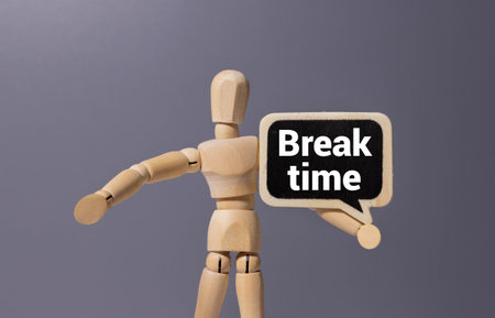 Break Time with wooden blocks alphabet letters and alarm clock on wooden backgroundの写真素材