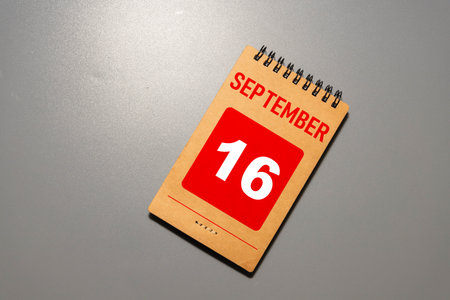 September 16. Date of September month. Number Cube with a flower and notebook on Diamond wood table for the background.の写真素材