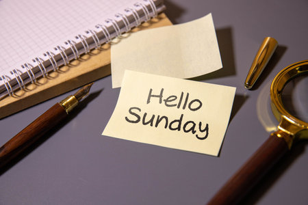 Hello Sunday text message with easel stand on wooden backgroundの写真素材