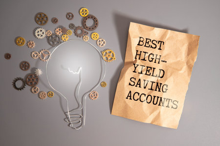 Business and finance. On the blue financial charts is a piece of cardboard that says - Best High-Yield Saving Accountsの写真素材