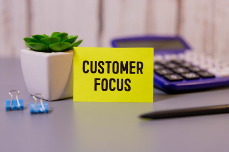 Customer wording on wooden cube block with red target board with arrow drawing for business customer focus and target concept. Putting wooden cubes with focused on target customer symbols.の写真素材