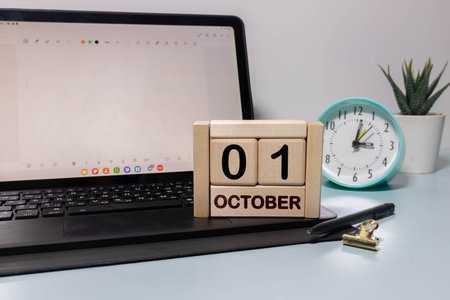 October 1st. Image of October 1 wooden color calendar on blue background. Autumn day. Empty space...