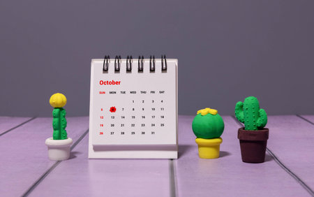 Wooden calendar with the date October 6.Monthly calendar for planning and management concept with alarm clock on wooden backgroundの写真素材