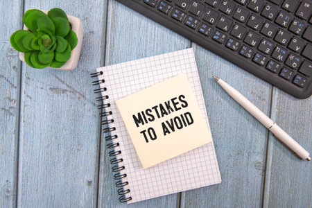 Mistakes To Avoid open notepad with text. bright stickers point to text