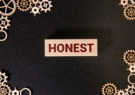 Honesty message written on torn cardboard paper with red background. Conceptual honesty symbol. Copy space.の写真素材