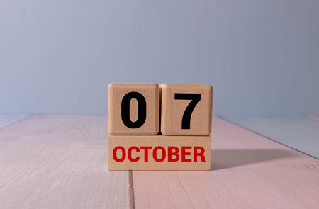 Wooden calendar organizer with date October 07 on table