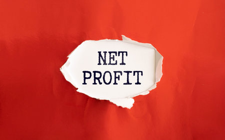 A colored sticker with the text NET PROFIT lies on the calculator.の写真素材