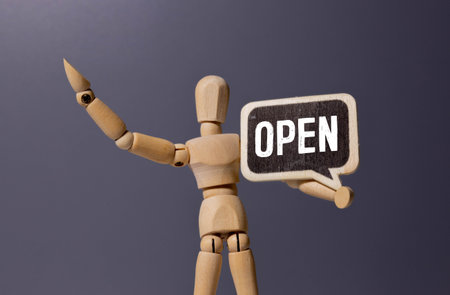 Open, sign and person at window of cafe for small business, information and start of service. Coffee shop, hospitality and waiter with board by glass for restaurant, message and beginning of work dayの写真素材