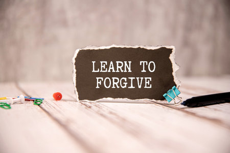 Notebook and pen on purple background with handwritten text DEAR PAST SELF, concept of self reflection - writing letter to the person you were, advice to give to tell about what happened then and nowの写真素材