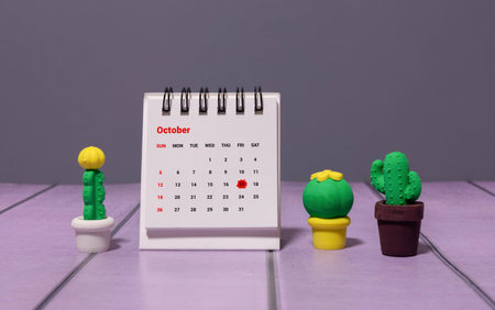 Wooden calendar with the date October 17.Monthly calendar for planning and management concept with alarm clock on wooden backgroundの写真素材