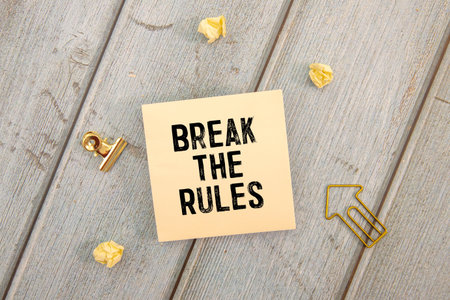yellow sticker with the text break the rules and charts.の写真素材