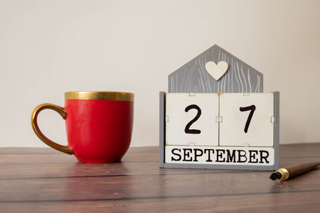 Vintage photo, September 27th. Date of September 27 on wooden cube calendar, copy space for text on boardの写真素材