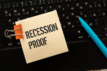 On the yellow surface lies an open lock with a key, next to it is a sticker with the inscription - Price lock.の写真素材