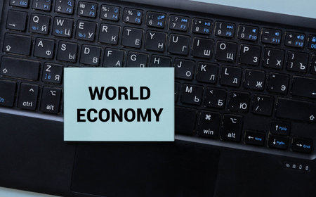 ECONOMIC SUMMIT text on card held by hands, concept for global meetings, finance, business, cooperation, and market discussions in the world of economy and tradeの写真素材