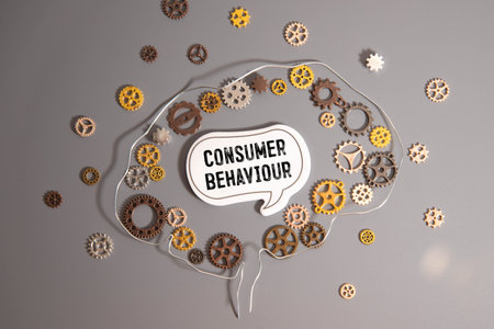 mini black board with text consumer behavior isolated on wooden backgroundの写真素材