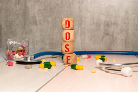 DOSE Word Written In Wooden Cubes On an isolated light table.の写真素材