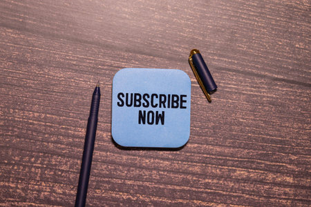 A card with the text SUBSCRIBE NOW. View from above.