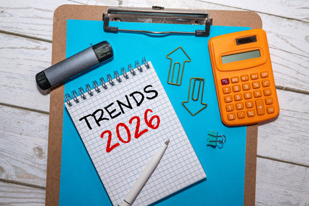 A person engages with a laptop displaying icons and text about future trends for 2026. The modern...