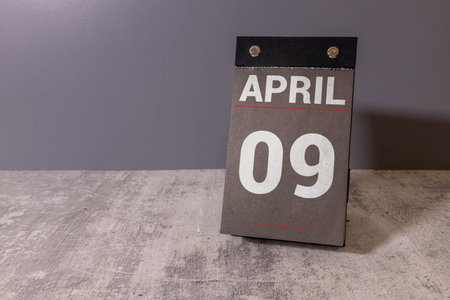 Wooden calendar displaying the date as April 09. This calendar serves as a decorative piece, marking the arrival of spring and facilitating event planning.の写真素材