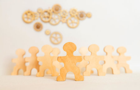 Hands of Business Team Aligning Metal Gears Symbolizing Unity, Collaboration, and Successful Organizational Strategyの写真素材