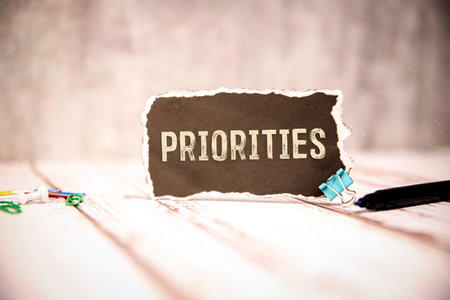 Priorities Concept on Torn Paper Note with Office Supplies
