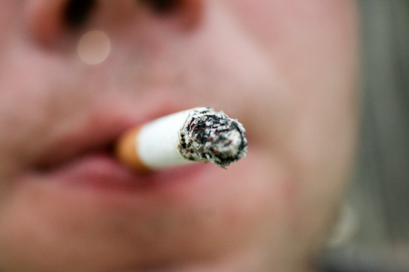 man smoking a cigarette close-upの写真素材