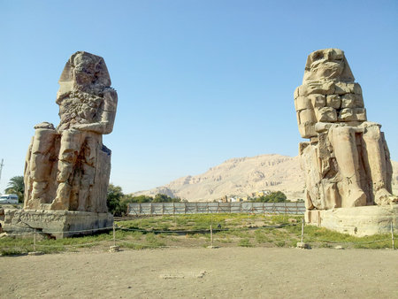 Egypt. Luxor. The Colossi of Memnon - two massive stone statues of Pharaoh Amenhotep IIIのeditorial素材