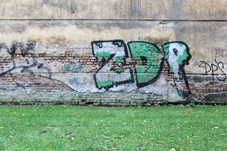 old and aged color graffiti drawing on the wall. Background grunge street art picture in Latvia Rigaのeditorial素材