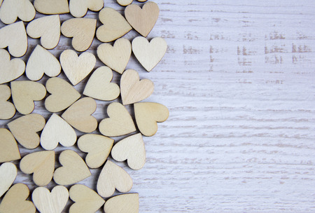 Heart shape from natural tree. Lovely heart shape by wooden small hearts on rustic wood table. Love theme concept with wooden hearts for Valentine's background and love theme. wooden leters i love you.の写真素材