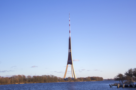 TV tower during winter time sunny day blue sky, high telecommunication tower in Riga, Latviaの写真素材