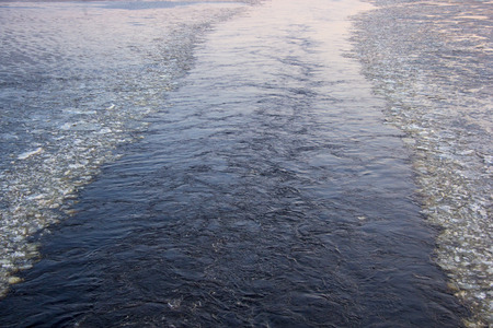 ferry road way from the waves and ice on the sea surface after the ship.の写真素材