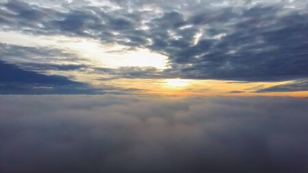 Fly Above the Clouds During Sunrise. Flying Drone Into the Misty Clouds at Evening.の写真素材